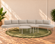 Load image into Gallery viewer, Elara curved outdoor sectional sofa in Warm Stone with plush cushions, slim aluminum frame, woven rope details, and two round nesting tables
