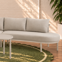 Load image into Gallery viewer, Elara curved outdoor sectional sofa in Warm Stone with plush cushions, slim aluminum frame, woven rope details, and two round nesting tables
