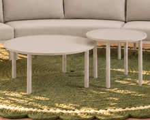 Load image into Gallery viewer, Elara curved outdoor sectional sofa in Warm Stone with plush cushions, slim aluminum frame, woven rope details, and two round nesting tables
