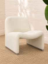 Load image into Gallery viewer, Etta white upholstered accent chair with rounded back, curved seat, sculptural side panels and silver-tone feet.
