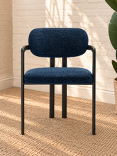Load image into Gallery viewer, Ezra midnight blue textured upholstered dining armchair with rounded back, open silhouette, and black metal frame
