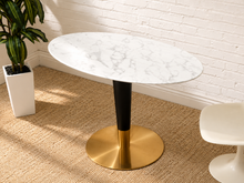 Load image into Gallery viewer, Oval white marble dining table with black pedestal column and round brushed brass base
