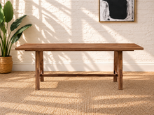 Load image into Gallery viewer, Felipe rectangular solid acacia dining table in natural brown with angled trestle legs, center stretcher and visible wood grain.
