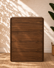 Load image into Gallery viewer, Finley five-drawer dresser in warm walnut with natural wood grain, rounded corners and handle-free push-to-open drawer fronts.

