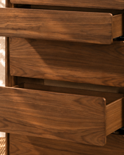 Load image into Gallery viewer, Finley five-drawer dresser in warm walnut with natural wood grain, rounded corners and handle-free push-to-open drawer fronts.
