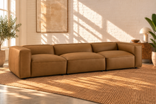Load image into Gallery viewer, Florence three-piece modular sectional sofa in caramel vegan leather with deep seats, low backrests, and wide upholstered arms
