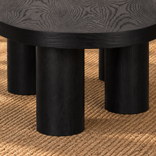 Load image into Gallery viewer, Henry solid oak coffee table in Natural Black with organic rounded tabletop, four cylindrical legs, and visible natural oak grain.
