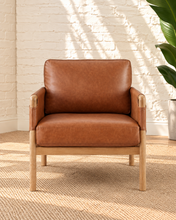 Load image into Gallery viewer, Hilario lounge chair in toasted cognac faux leather with solid ash wood frame and rounded wooden arms
