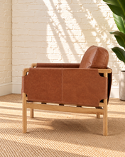 Load image into Gallery viewer, Hilario lounge chair in toasted cognac faux leather with solid ash wood frame and rounded wooden arms
