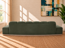 Load image into Gallery viewer, Jackie sofa in Olive Branch velvet with deep channel tufting, curved silhouette, and natural-finish rounded rubberwood base.
