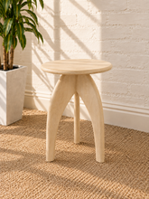 Load image into Gallery viewer, Jillian side table in sand-finished mango wood with an elongated oval tabletop, rounded edges, and sculptural tapered pedestal base.
