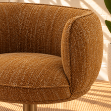Load image into Gallery viewer, Jorina ochre bouclé swivel accent chair with rounded curved back, cushioned seat, textured upholstery, and concealed iron swivel base.
