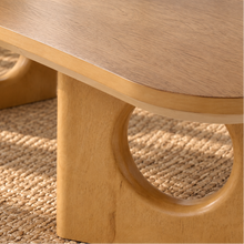Load image into Gallery viewer, Kamari natural oak rectangular coffee table with rounded corners and two sculptural panel legs featuring circular cutouts.
