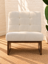 Load image into Gallery viewer, Karyl Ivory armless accent chair with ivory tufted upholstery, removable cushions and sculptural walnut-finished oak wood frame.
