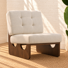 Load image into Gallery viewer, Karyl Ivory armless accent chair with ivory tufted upholstery, removable cushions and sculptural walnut-finished oak wood frame.
