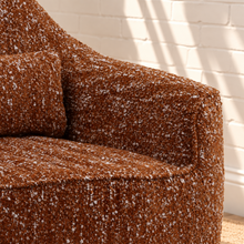 Load image into Gallery viewer, Katiana rust chunky bouclé swivel accent chair with rounded back, curved arms, cushioned seat, and dark rubber wood base.
