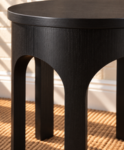 Load image into Gallery viewer, Kaylee sculptural side table in charcoal black with rounded top and arched openwork base.
