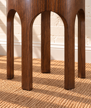 Load image into Gallery viewer, Kaylee sculptural side table in natural brown with a round top and arched Art Deco-inspired base.
