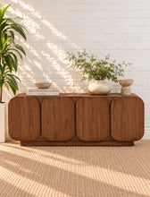 Load image into Gallery viewer, Keanu natural brown mindi wood credenza with four rounded cabinet doors, curved corners, low plinth base, and interior shelving.


