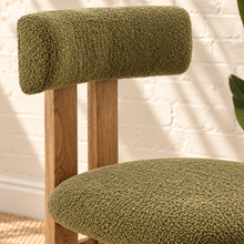 Load image into Gallery viewer, Sandra dining chair with avocado green bouclé upholstered seat and backrest, high-density foam cushioning and natural solid ash wood frame.
