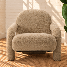 Load image into Gallery viewer, Kinsley latte beige textured upholstered accent chair with rounded back, cushioned seat and sculptural arms and legs.
