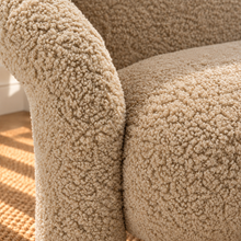 Load image into Gallery viewer, Kinsley latte beige textured upholstered accent chair with rounded back, cushioned seat and sculptural arms and legs.
