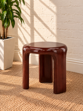 Load image into Gallery viewer, Image 1 of 5: Klarisse sculptural side table in chestnut high-gloss concrete with a rounded top and three curved integrated legs.
