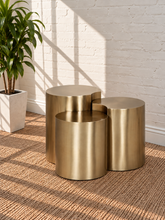 Load image into Gallery viewer, Klein three-piece Orbit nesting side tables in brushed gold with rounded cylindrical forms.
