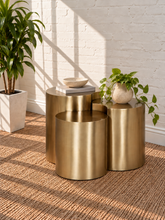 Load image into Gallery viewer, Klein three-piece Orbit nesting side tables in brushed gold with rounded cylindrical forms.
