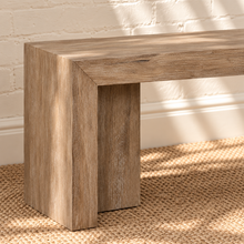 Load image into Gallery viewer, Kollie natural wood bench with long rectangular seat, waterfall-style ends and visible acacia wood grain.
