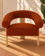 Load image into Gallery viewer, Kourtney burnt orange textured accent chair with curved flared arms, cushioned seat and natural wood legs.
