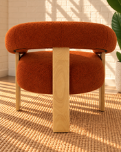 Load image into Gallery viewer, Kourtney burnt orange textured accent chair with curved flared arms, cushioned seat and natural wood legs.
