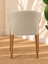 Load image into Gallery viewer, Kyra greige vegan leather dining armchair with curved back, sculpted solid ash wood arms and legs, and cushioned seat.
