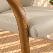 Load image into Gallery viewer, Kyra greige vegan leather dining armchair with curved back, sculpted solid ash wood arms and legs, and cushioned seat.
