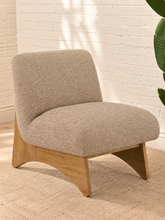 Load image into Gallery viewer, Kyro oat beige upholstered slipper chair with rounded tight back, cushioned seat and sculptural oak veneer wood legs.
