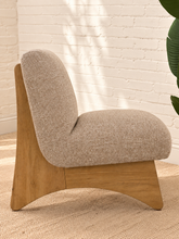 Load image into Gallery viewer, Kyro oat beige upholstered slipper chair with rounded tight back, cushioned seat and sculptural oak veneer wood legs.
