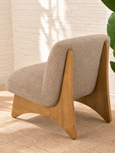 Load image into Gallery viewer, Kyro oat beige upholstered slipper chair with rounded tight back, cushioned seat and sculptural oak veneer wood legs.
