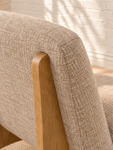 Load image into Gallery viewer, Kyro oat beige upholstered slipper chair with rounded tight back, cushioned seat and sculptural oak veneer wood legs.

