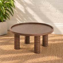 Load image into Gallery viewer, Lainey round dark walnut coffee table with raised rim, visible wood grain and four chunky ring-turned wood legs.
