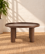 Load image into Gallery viewer, Lainey round dark walnut coffee table with raised rim, visible wood grain and four chunky ring-turned wood legs.

