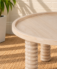 Load image into Gallery viewer, Lainey natural wood round coffee table with raised rim, subtle wood grain and four chunky ring-turned legs.
