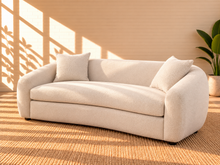 Load image into Gallery viewer, Image 3 of 5: Leighton upholstered sofa in Cloud Ivory fabric with rounded silhouette, sloped arms, broad bench seat, and black legs
