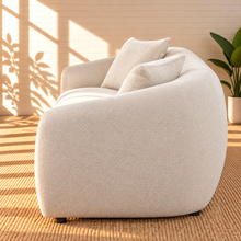Load image into Gallery viewer, Image 4 of 5: Leighton upholstered sofa in Cloud Ivory fabric with rounded silhouette, sloped arms, broad bench seat, and black legs
