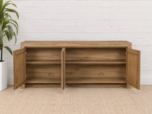 Load image into Gallery viewer, Levi three-door media cabinet in natural acacia wood with clean handle-free doors, visible wood grain and a low framed base.
