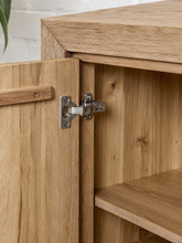 Load image into Gallery viewer, Levi three-door media cabinet in natural acacia wood with clean handle-free doors, visible wood grain and a low framed base.
