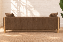 Load image into Gallery viewer, Lexi three-seat sofa upholstered in textured taupe brown fabric with exposed solid wood legs, square arms, and two matching toss pillows.

