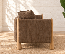 Load image into Gallery viewer, Lexi three-seat sofa upholstered in textured taupe brown fabric with exposed solid wood legs, square arms, and two matching toss pillows.
