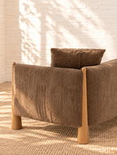 Load image into Gallery viewer, Lexi three-seat sofa upholstered in textured taupe brown fabric with exposed solid wood legs, square arms, and two matching toss pillows.
