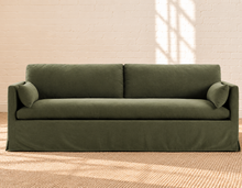 Load image into Gallery viewer, Liana olive linen-blend slipcovered sofa with deep bench cushion, two back cushions, and matching throw pillows
