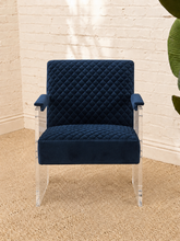 Load image into Gallery viewer, Lucian navy blue velvet accent chair with diamond-quilted upholstery, padded armrests and clear acrylic legs.
